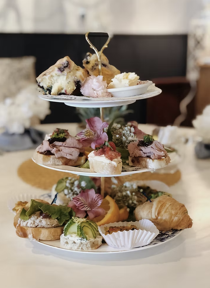 A three-tiered afternoon tea tray with house-made tea sandwiches, pastries, desserts, and tea-time treats at Teapots & Treasures Café.